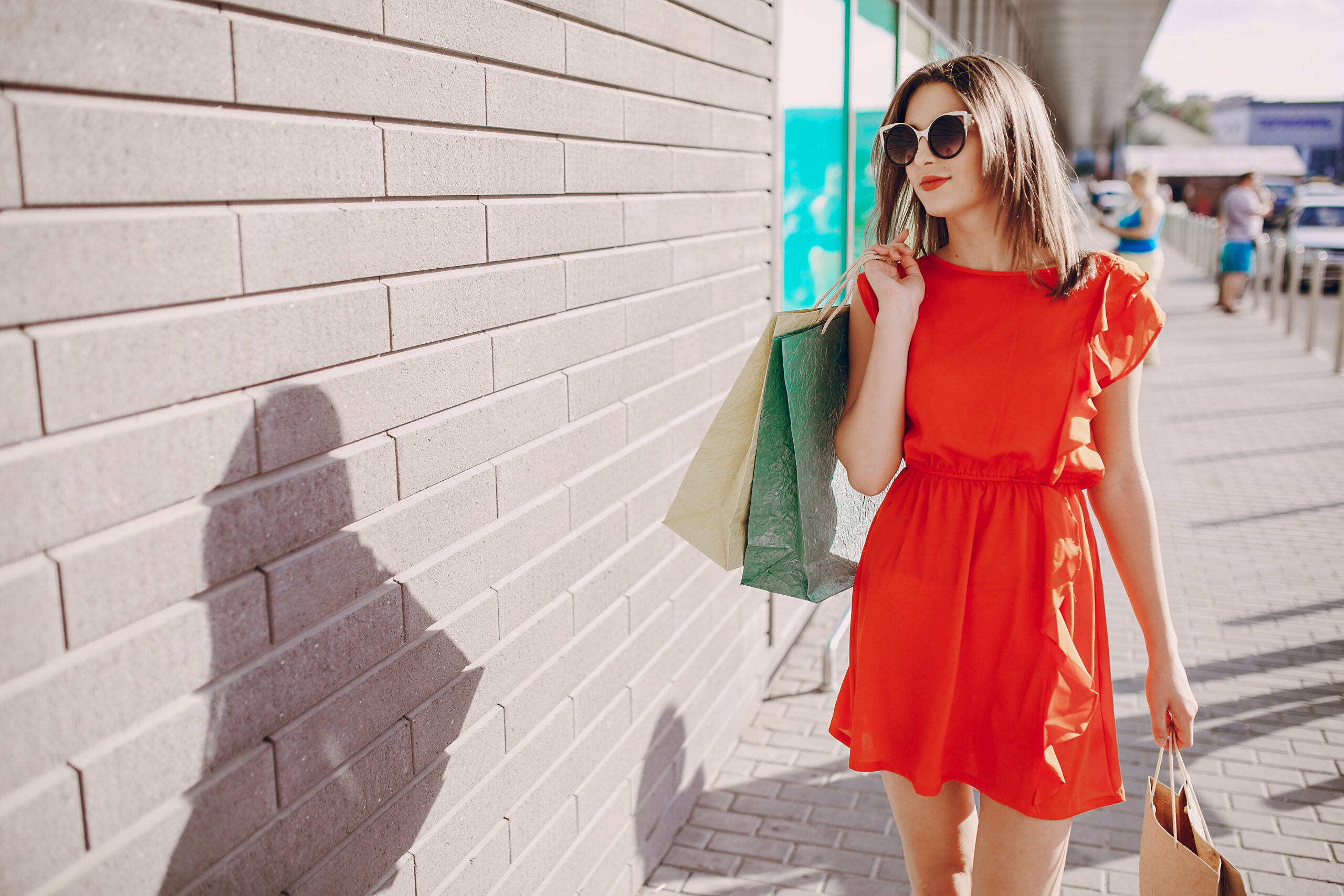 two beautiful young women walk to the shops and make purchases